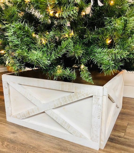 a planter that is sitting in front of a christmas tree