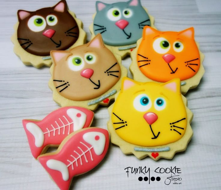 decorated cookies in the shape of cats and fish