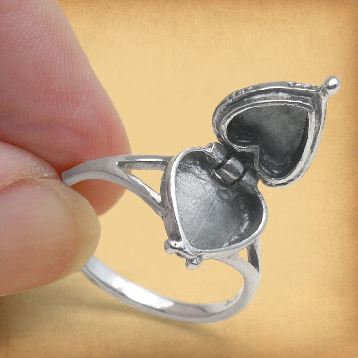 Our sterling silver Heart Poison Ring has a hidden surprise! The hinged top flips up to reveal a secret compartment below. We don't recommend it for actual murder and mayhem, but if you enjoy out-of-the-ordinary jewelry, this certainly fits the bill. Poison rings are also sometimes called locket rings, box rings, or pillbox rings. They seem to have originated in the far East, possibly India. It wasn't until the the Middle Ages, however, that the rings were introduced to western culture. The Borg Pillbox Ring, Box Rings, Rings Box, The Borg, Celtic Cross Stitch, Poison Ring, Locket Ring, Leather Bound Journal, Soldering Jewelry