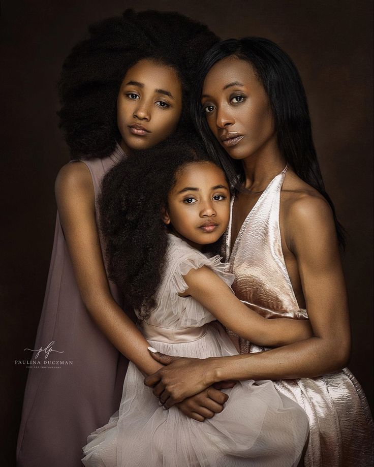 three women are hugging each other and posing for the camera