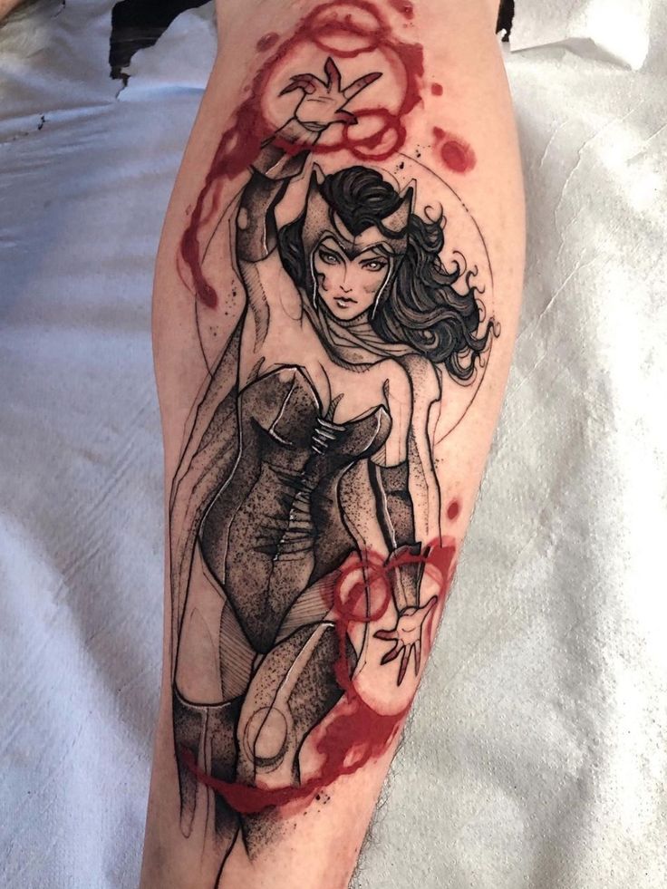 a woman's leg covered in blood and ink with a tattoo design on it