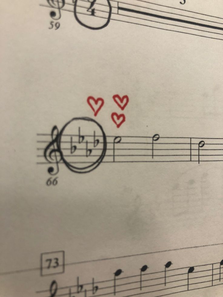 sheet music with musical notes and hearts drawn on it