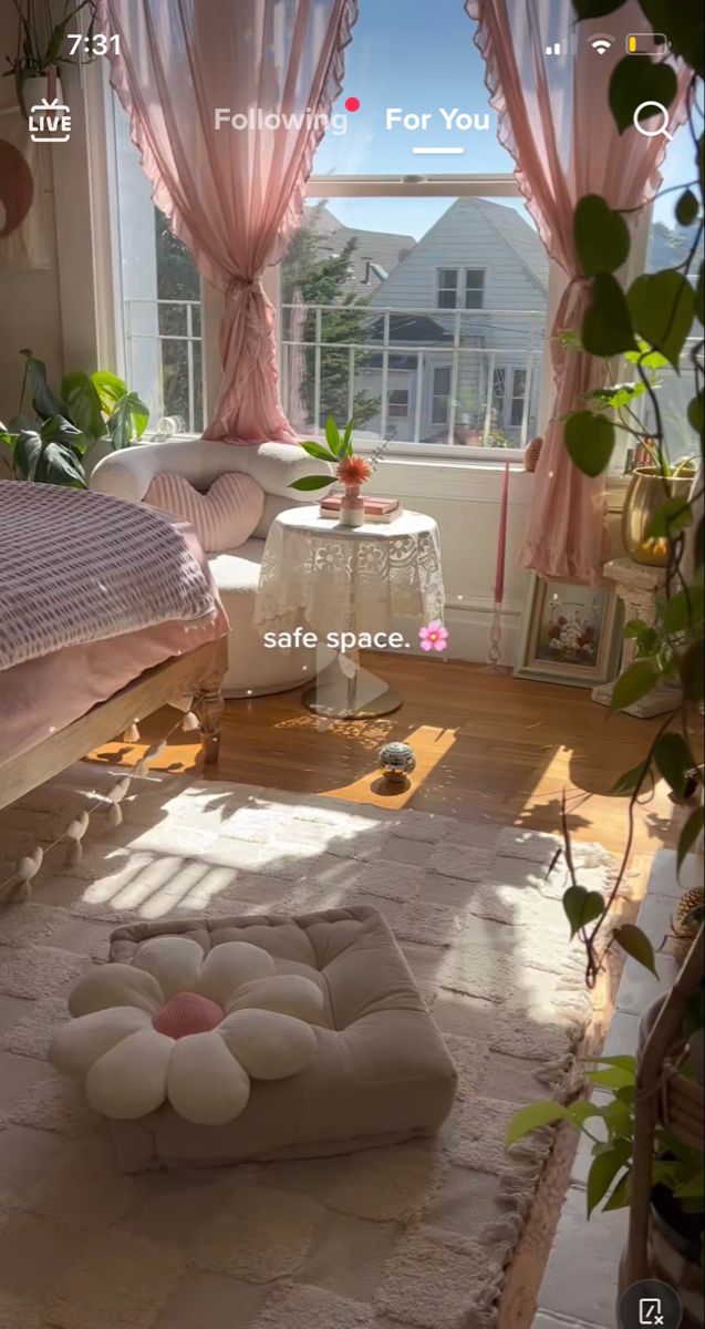 a bedroom with pink curtains and furniture in the sun light, is shown on an iphone screen