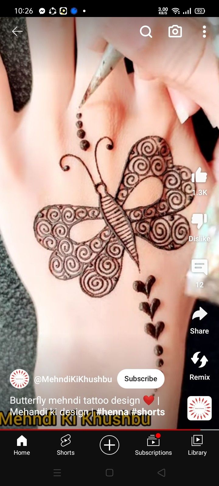 the hendi tattoo design is being done on someone's hand and it looks like a butterfly