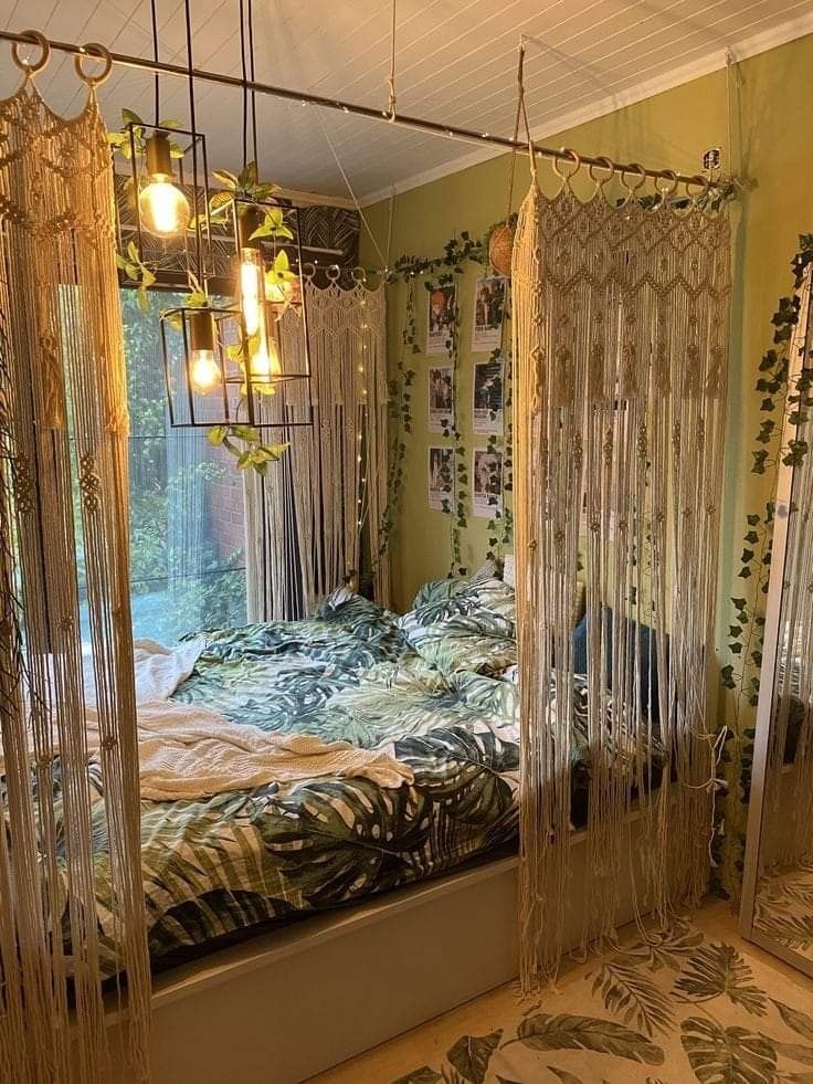 a bedroom with two beds and hanging curtains