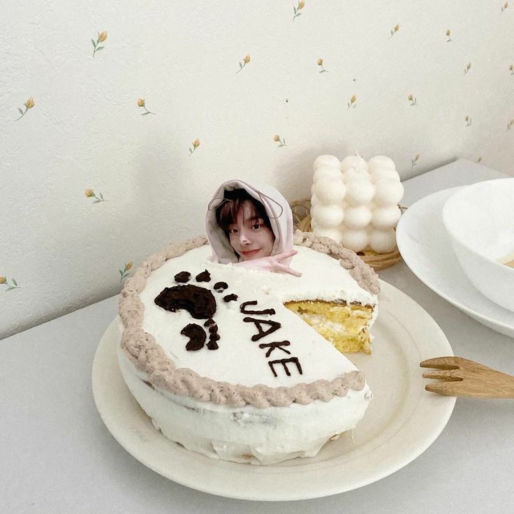 there is a cake on the table with a doll next to it