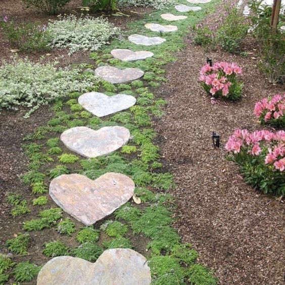 several heart shaped stepping stones in a garden