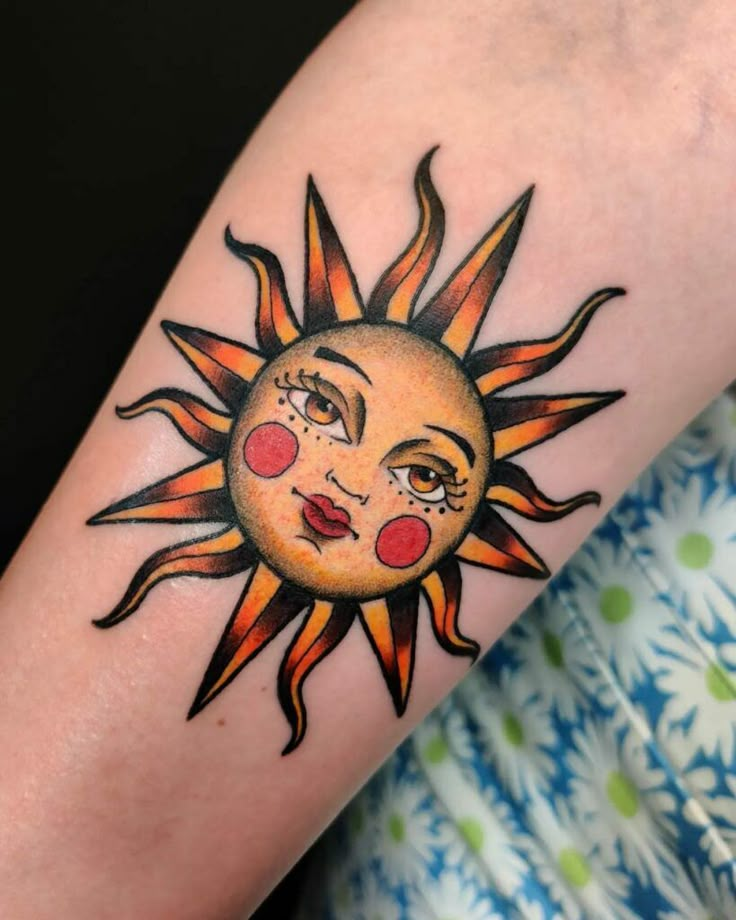 a sun tattoo on the arm with red eyes