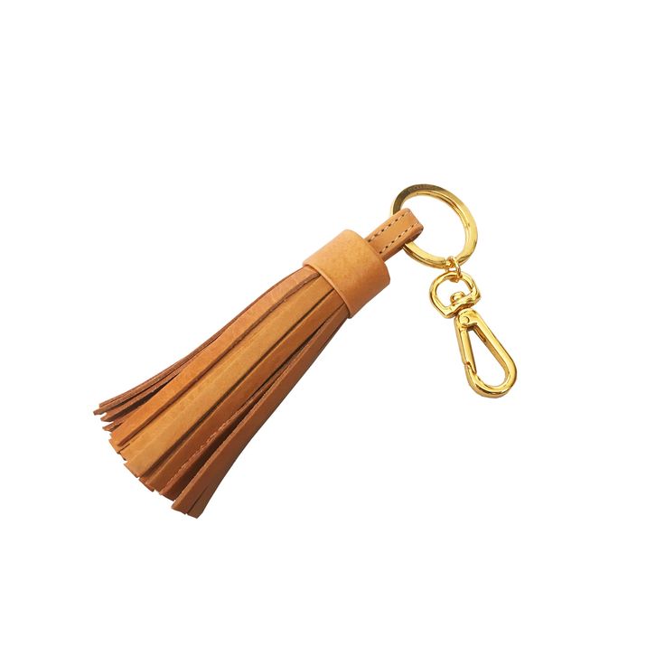 a leather keychain with a tassel hanging from it's side on a white background