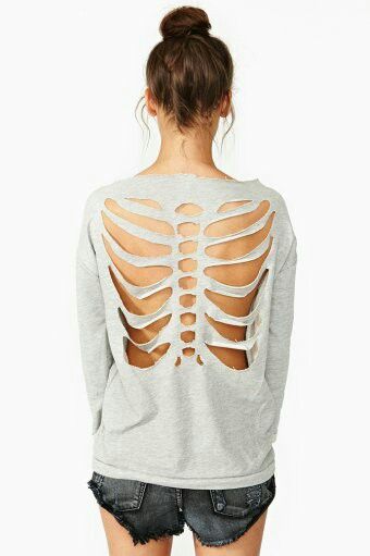 the back of a woman's shirt with cutouts on it