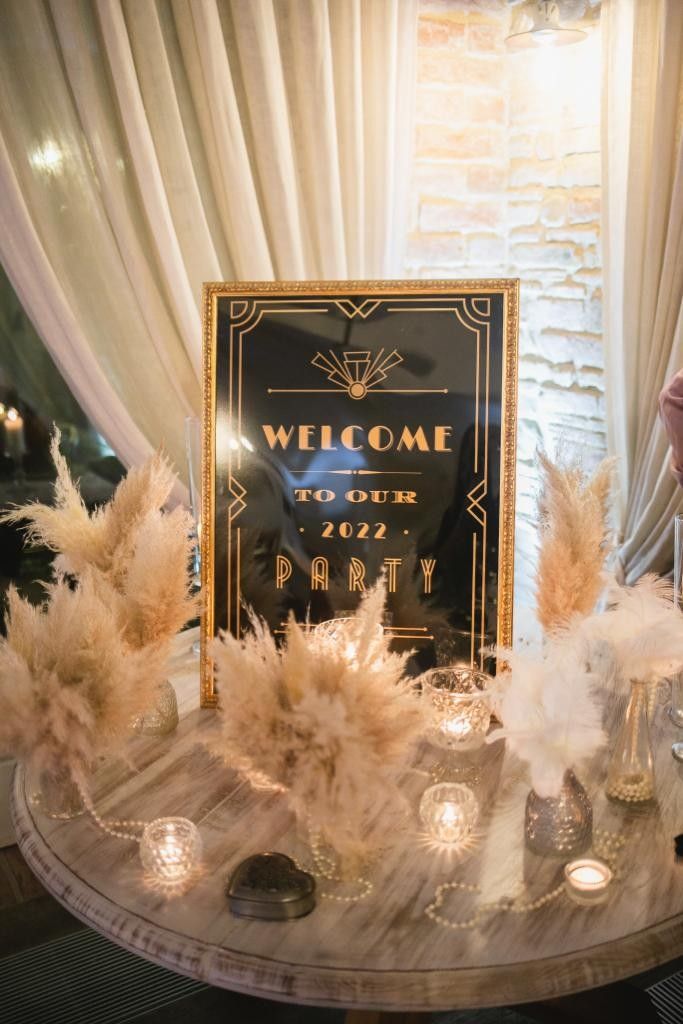 a welcome sign and some candles on a table