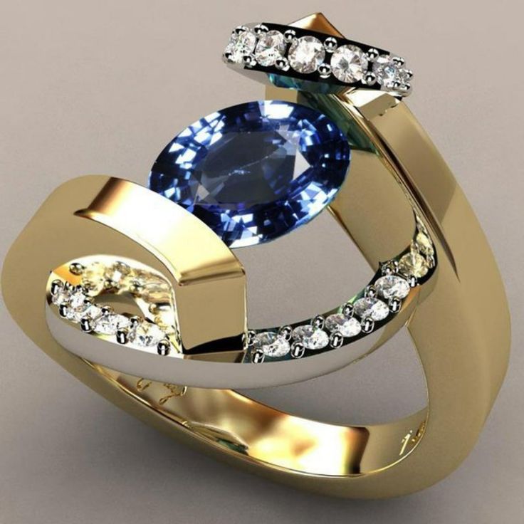 a gold ring with blue and white stones