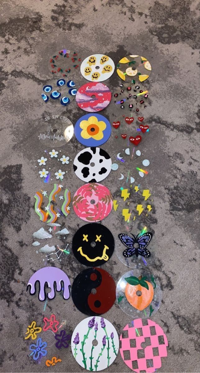 a number of different types of buttons on the ground with one being painted and another being decorated