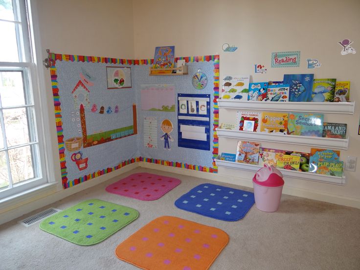 a child's playroom with colorful rugs and bookshelves on the wall