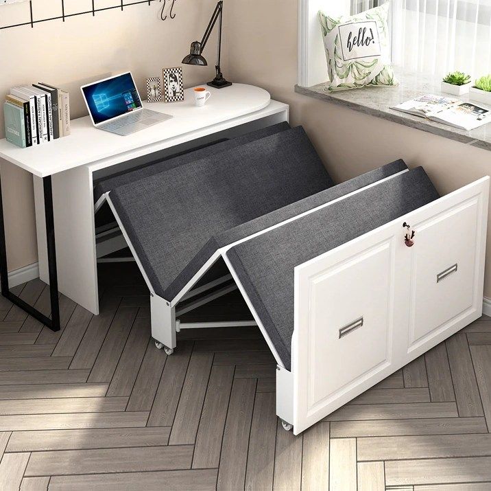 a desk with a laptop on top of it and an open drawer underneath the desk