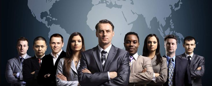 a group of business people standing in front of a world map on a dark background