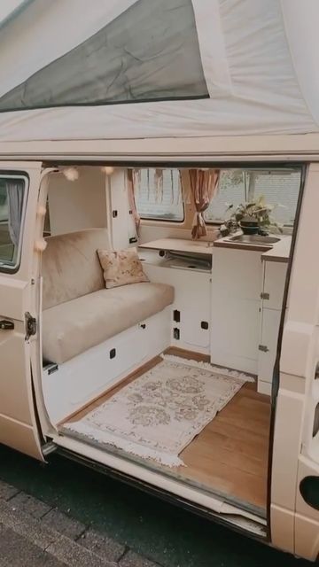 the inside of a van with its door open and couch in the back ground next to it