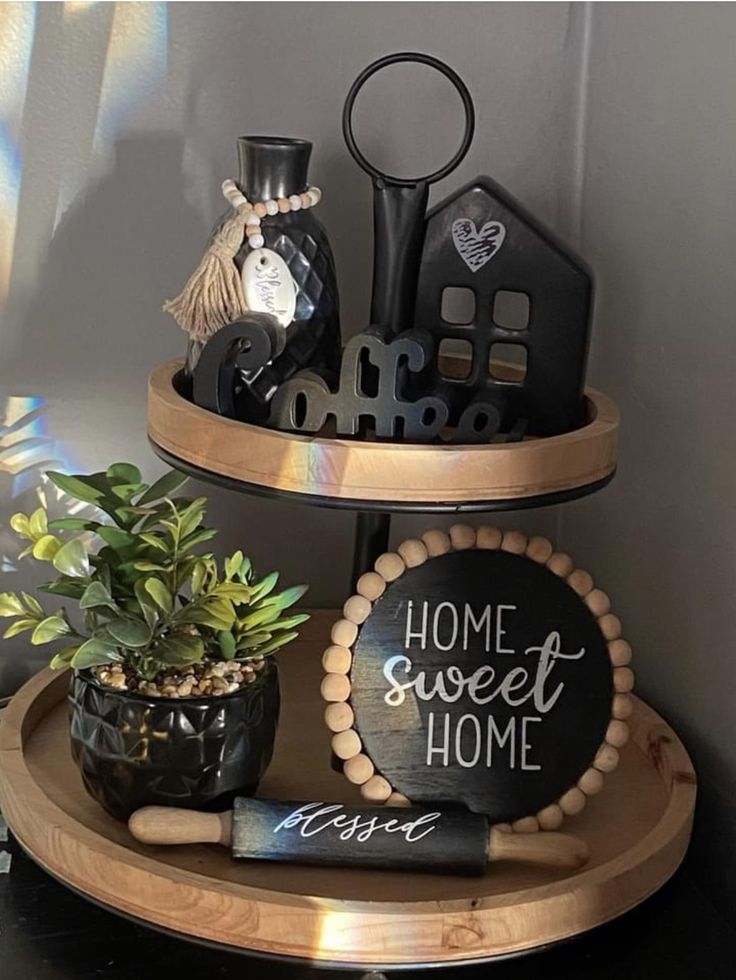 two tiered trays holding various items on top of each other, including a potted plant