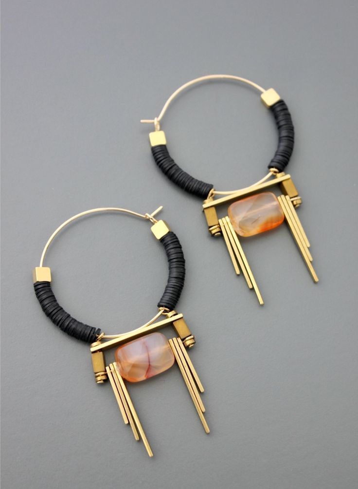 Established in 1997, David Aubrey pieces are timelessa bold statement for the moment as well as ten years from now. All pieces are handcrafted in the U.S. by skilled artisans who are passionate about quality and originality. - 18K gold plated - Brass hoop - Black vulcanite - Carnelian teardrop with brass drop detailing - Made in the USA Unique Finds, Brass Hoops, Bijoux Diy, Gold Drop Earrings, Artistic Jewelry, Jewelry Inspo, Diy Earrings, Metal Jewelry, Black And Gold