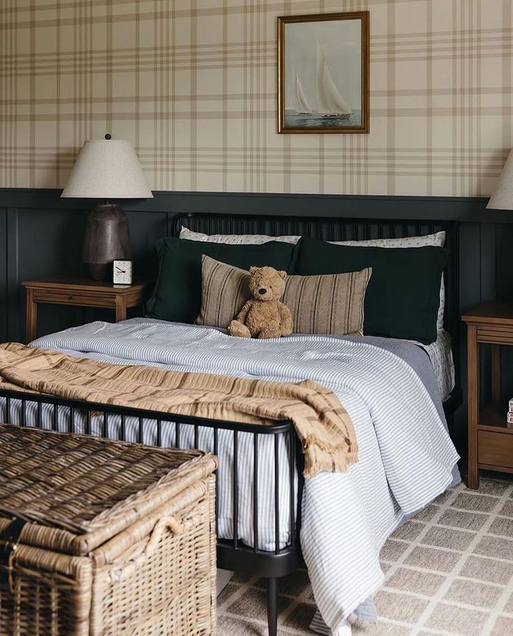 a teddy bear sitting on top of a bed in a bedroom