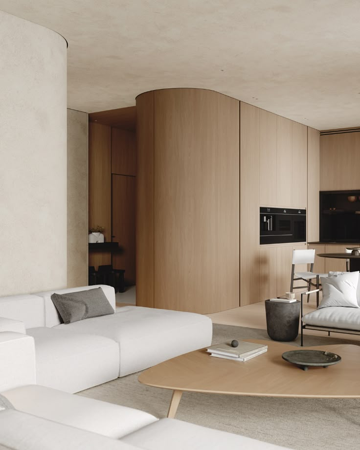 a living room filled with white furniture next to a wooden table and wall mounted tv