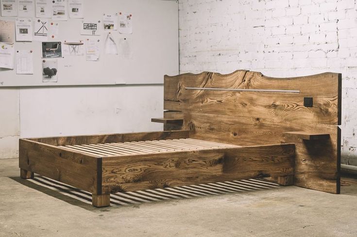 a bed frame made out of wood in a room