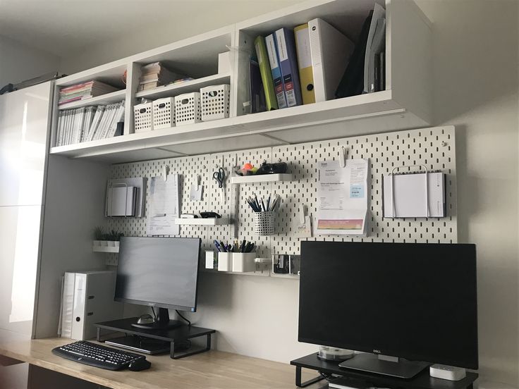 a desk with a computer monitor and keyboard on it