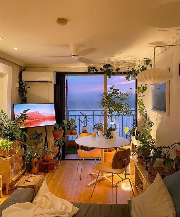 a living room filled with furniture and a flat screen tv sitting on top of a wooden floor