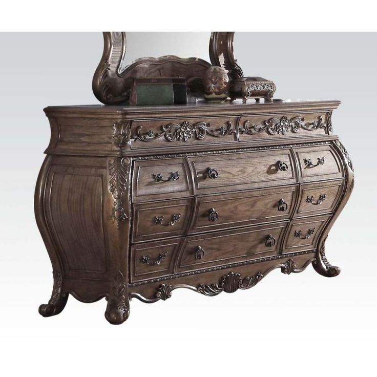 an ornate wooden dresser with mirror on it's top and bottom drawer, in front of a white background