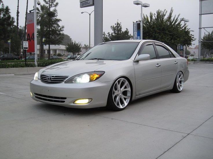 a silver car parked in front of a gas station