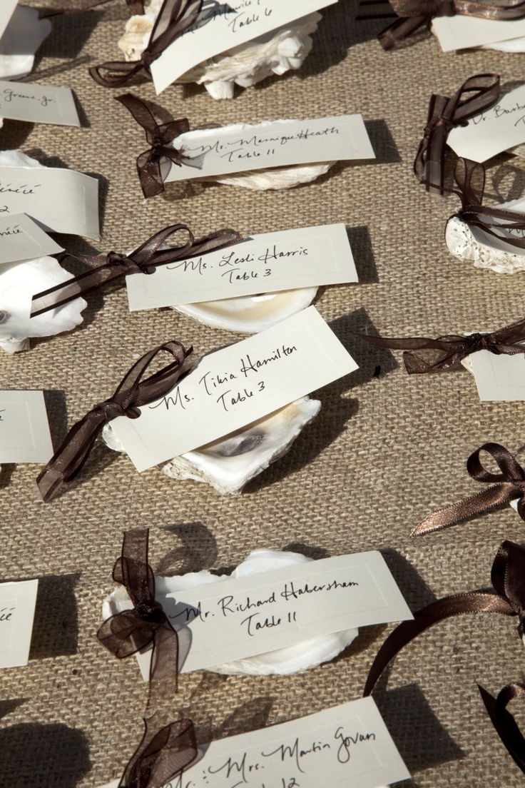 several pieces of paper that have been tied together with brown ribbons and tags on them