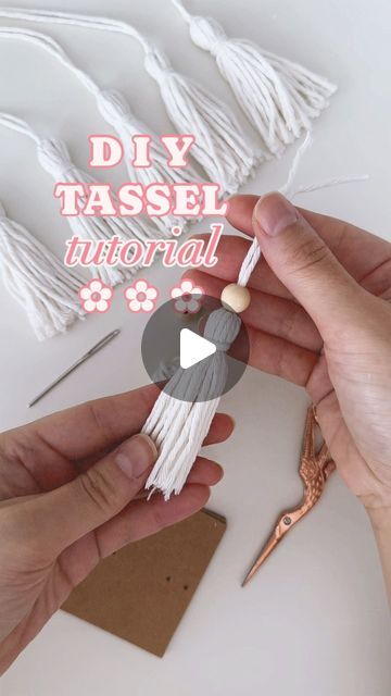 someone is making tassels with their hands