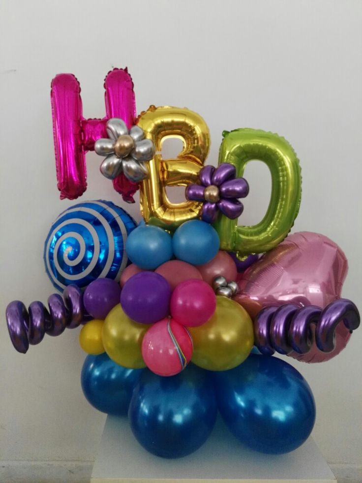 a bunch of balloons that are in the shape of letters on top of each other