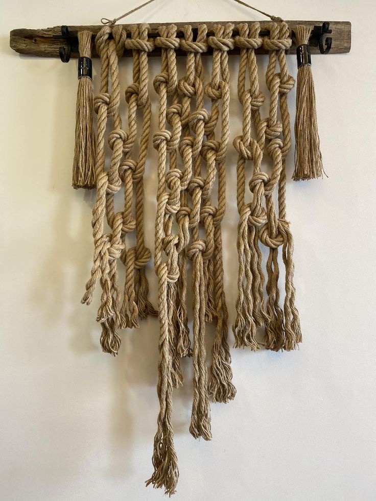 a wall hanging made out of rope and wood