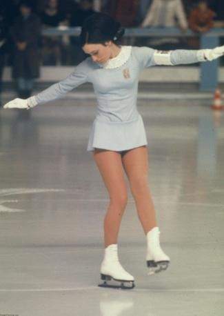 a woman is skating on the ice rink