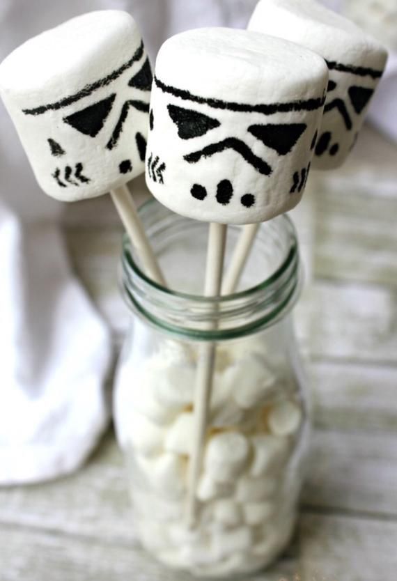 some marshmallows are sitting in a mason jar with the lids decorated to look like darth vader