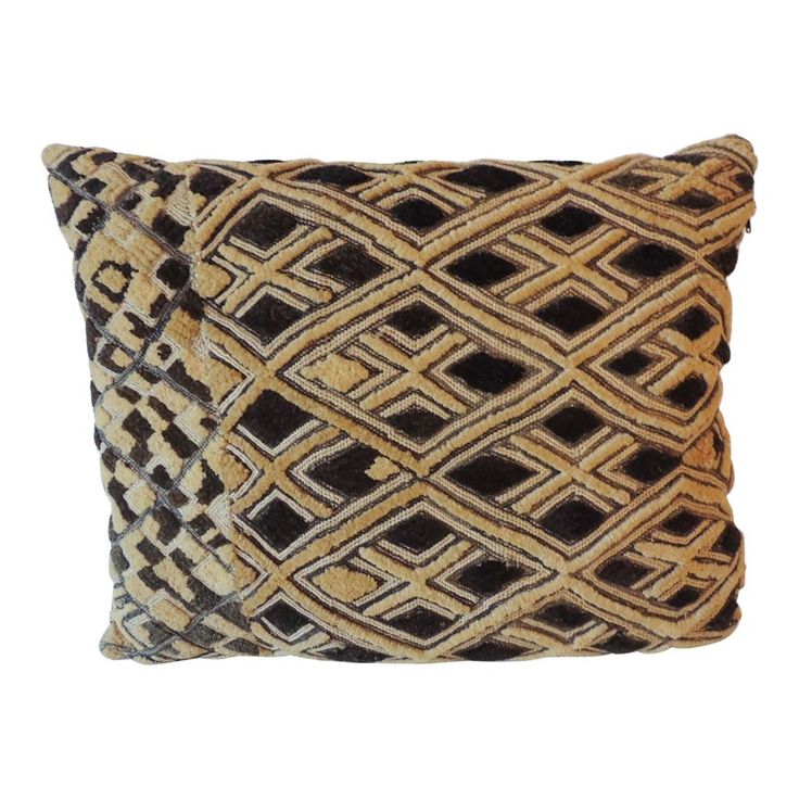 a brown and black pillow on a white background