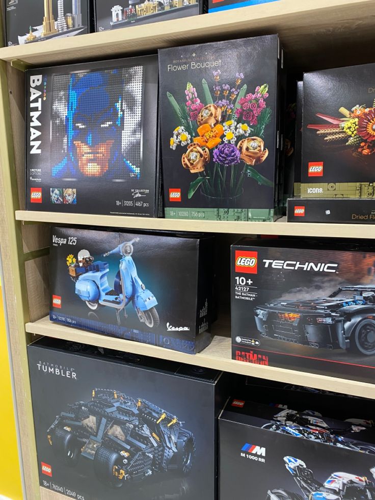 the lego batman movie set is on display in a toy store, with other toys behind it