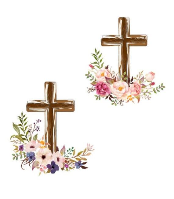 two wooden crosses decorated with flowers and greenery