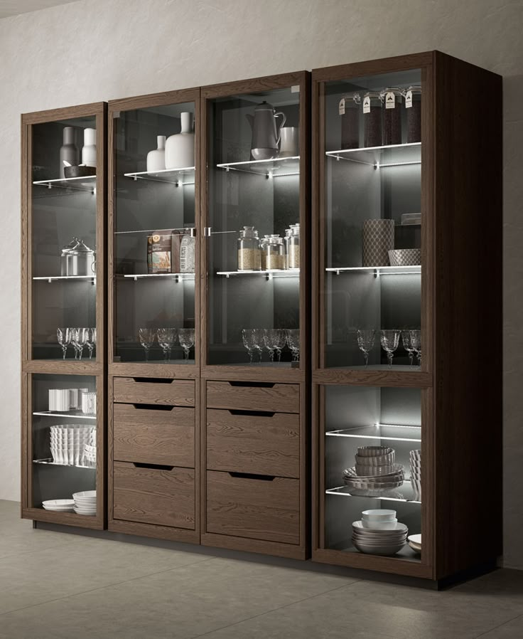 a large wooden cabinet with glass doors and shelves filled with dishes, glasses and other items