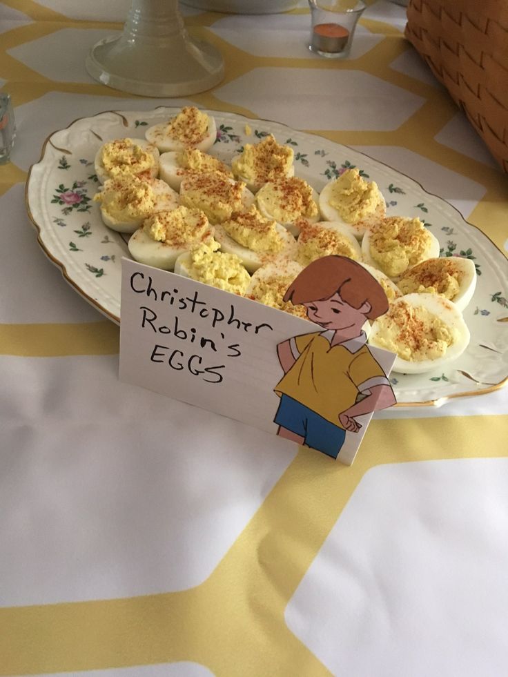 an egg tray with deviled eggs on it and a sign that says, chrstophro robin's eggs