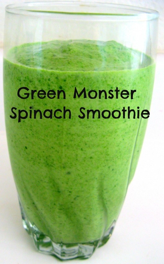 green monster spinach smoothie in a glass with the words, green monster spinach smoothie