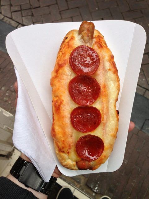 a hot dog with pepperoni and cheese on it in a paper container that says, pizzadog life is good