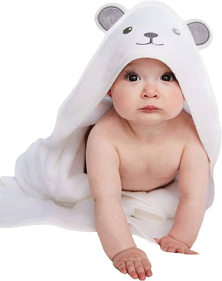 a baby wrapped in a white bear towel