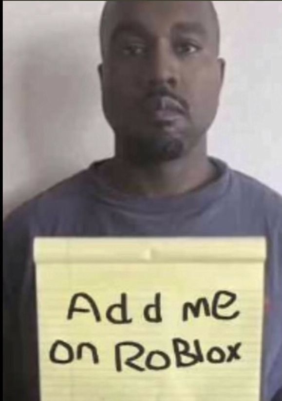 a man holding a sign that says add me on robox