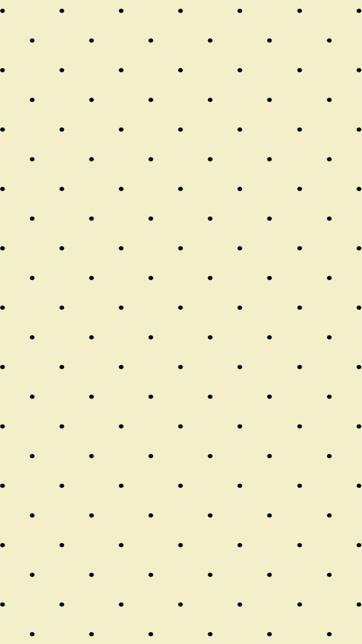 a black and white polka dot pattern on a beige wallpaper with dots in the middle