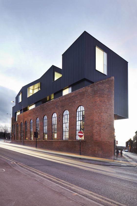 a large brick building sitting on the side of a road