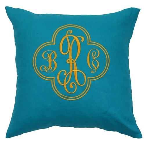 the monogrammed pillow is blue with gold trim