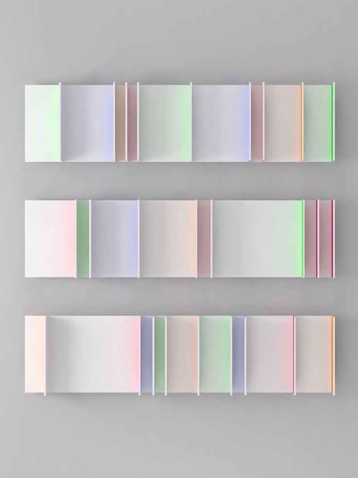 three rows of different colored papers on a gray background with white and pink lines in the middle