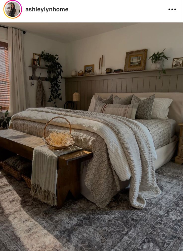 a bedroom with a large bed and lots of pillows